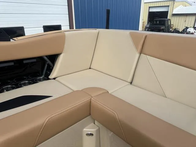 Slide: The Image of 2024 MasterCraft NXT21 boat interior with beige and tan seating. - 22