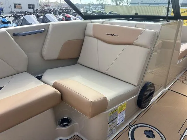 Slide: The Image of 2024 MasterCraft NXT21 boat interior with beige and tan seating, showcasing luxury and comfort. - 24