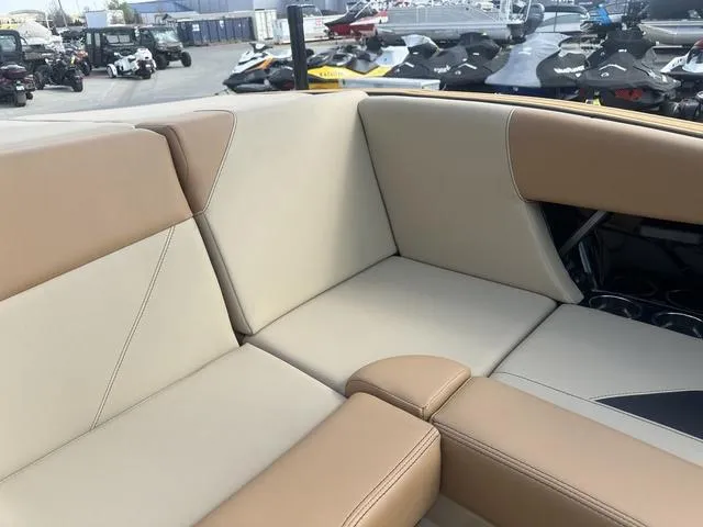 Slide: The Image of 2024 MasterCraft NXT21 boat interior with beige and tan seating. - 26