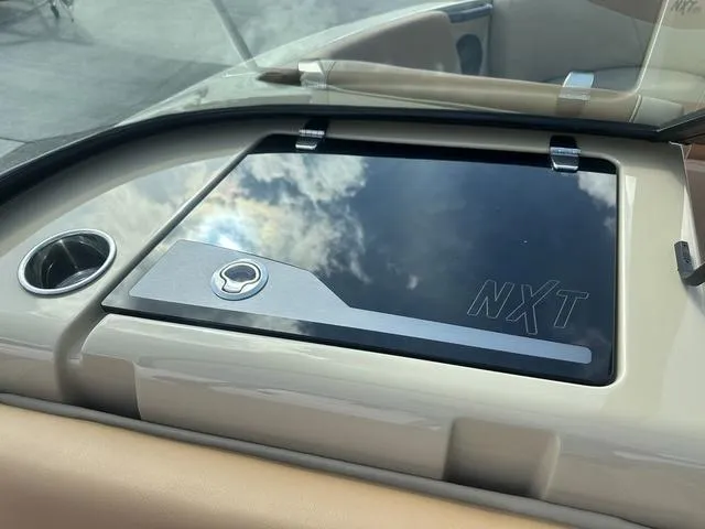 Slide: The Image of 2024 MasterCraft NXT21 dashboard with sleek design and cup holder. - 29