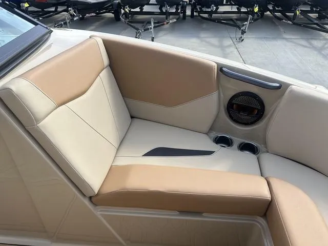 Slide: The Image of 2024 MasterCraft NXT21 boat interior with beige seating and built-in speaker. - 31