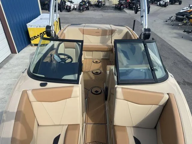 Slide: The Image of 2024 MasterCraft NXT21 boat interior with tan seating and open windshield. - 35