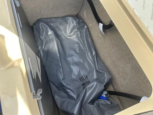 Slide: The Image of 2024 MasterCraft NXT21 storage compartment with a covered ballast bag. - 36