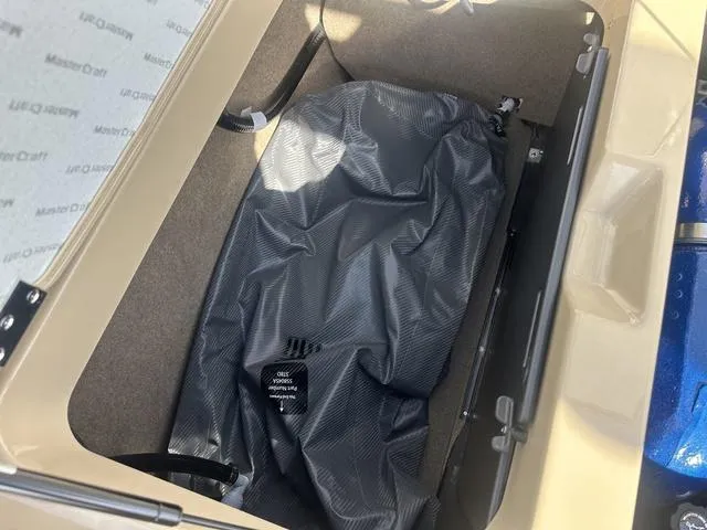 Slide: The Image of 2024 MasterCraft NXT21 storage compartment with a black cover inside. - 37