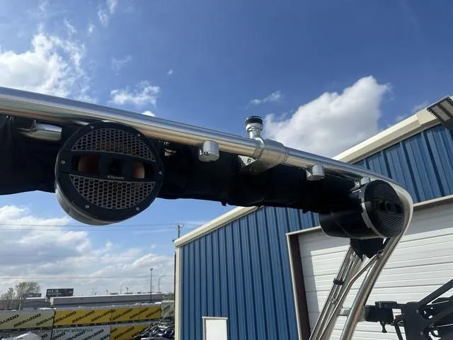 Slide: The Image of 2024 MasterCraft NXT21 boat speakers and tower against a blue sky backdrop. - 38