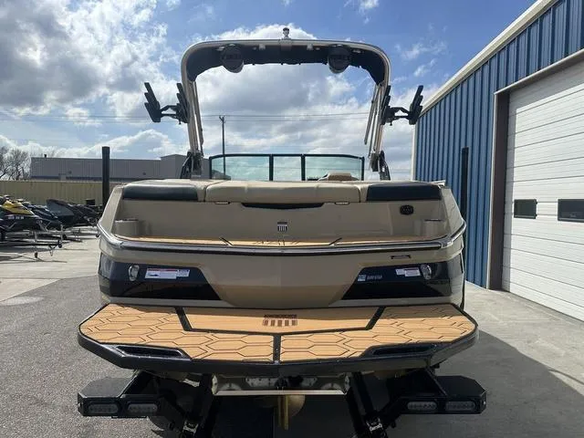 Slide: The Image of 2024 MasterCraft NXT21 boat rear view, showcasing swim platform and sleek design. - 7