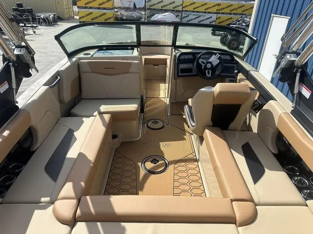 Slide: The Image of 2024 MasterCraft NXT21 boat interior with tan seating and modern dashboard. - 9