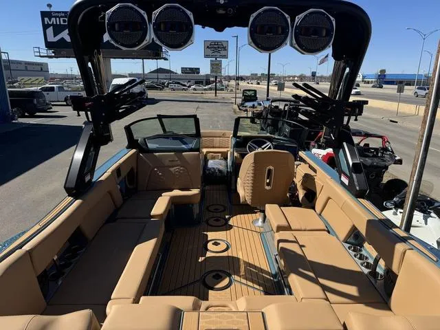 Slide: The Image of 2025 MasterCraft X24 boat interior with tan seating and advanced audio system. - 10