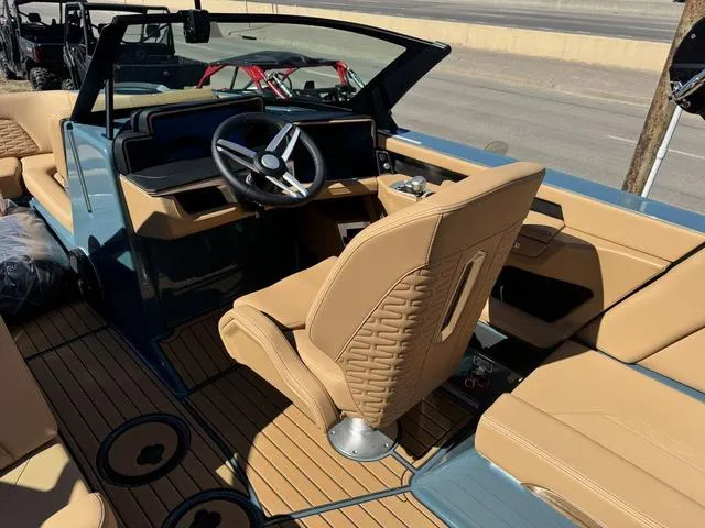 Slide: The Image of 2025 MasterCraft X24 boat interior with tan leather seats and modern dashboard. - 11