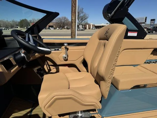 Slide: The Image of 2025 MasterCraft X24 boat interior with tan leather seats and modern steering wheel. - 12