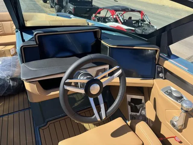 Slide: The Image of 2025 MasterCraft X24 boat dashboard with modern steering wheel and digital displays. - 13