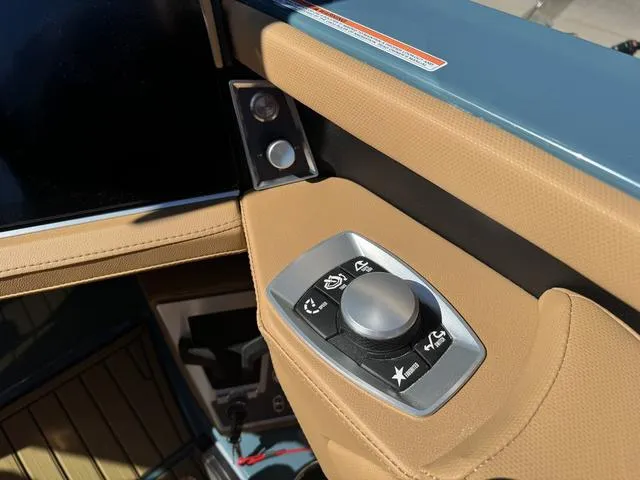 Slide: The Image of Control panel of 2025 MasterCraft X24 boat with tan upholstery and modern design. - 14