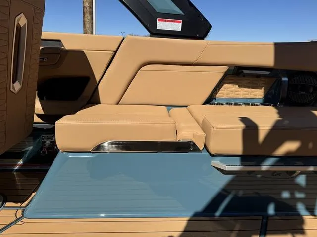 Slide: The Image of 2025 MasterCraft X24 boat interior with tan leather seating and sleek design elements. - 16
