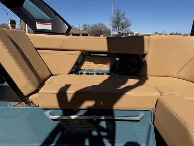 Slide: The Image of 2025 MasterCraft X24 boat interior with tan leather seating and cup holders. - 18