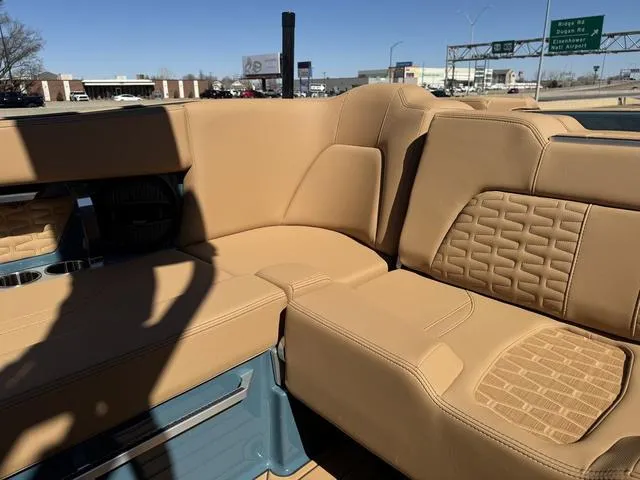 Slide: The Image of 2025 MasterCraft X24 boat interior with tan leather seating and modern design. - 19