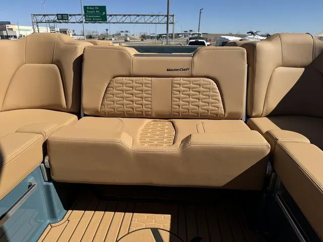 Slide: The Image of 2025 MasterCraft X24 boat interior with tan leather seating and modern design. - 20