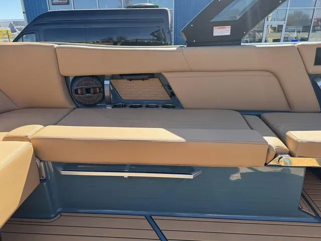 Slide: The Image of 2025 MasterCraft X24 boat interior with tan seating and built-in speakers. - 24