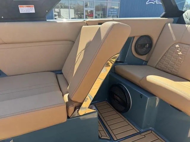 Slide: The Image of 2025 MasterCraft X24 boat interior with tan seating and modern design. - 26