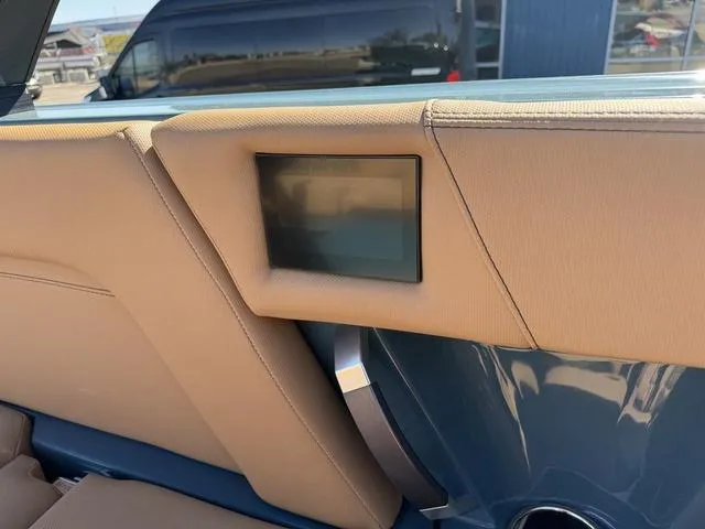 Slide: The Image of 2025 MasterCraft X24 interior detail with beige upholstery and built-in screen. - 28