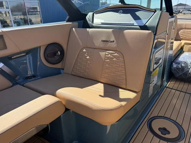 Slide: The Image of 2025 MasterCraft X24 boat interior with tan leather seats and modern design. - 29