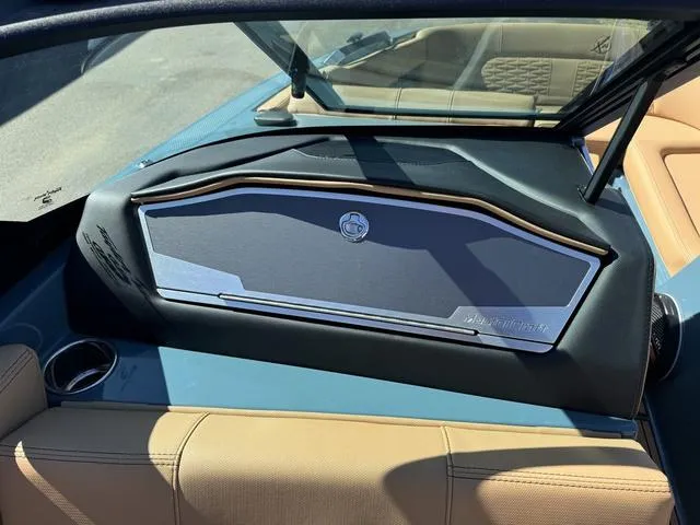 Slide: The Image of 2025 MasterCraft X24 boat dashboard with sleek design and tan seating. - 30