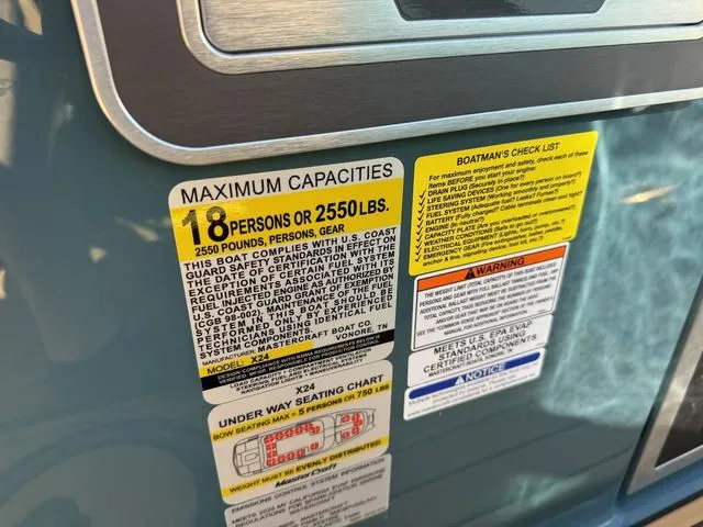Slide: The Image of 2025 MasterCraft X24 capacity label, maximum 18 persons or 2550 lbs, safety instructions visible. - 31