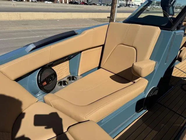 Slide: The Image of 2025 MasterCraft X24 boat interior with tan leather seats and built-in speakers. - 34