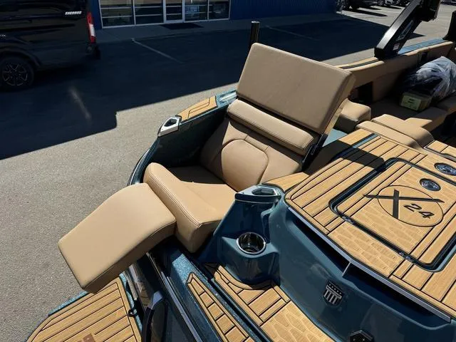 Slide: The Image of 2025 MasterCraft X24 boat interior with tan seating and wood accents. - 37