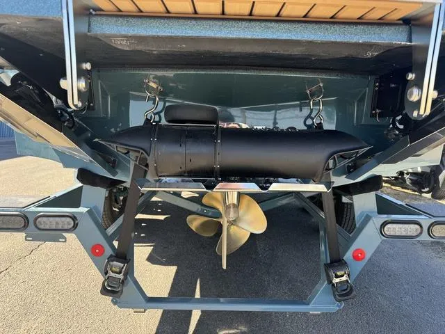 Slide: The Image of 2025 MasterCraft X24 boat stern with propeller and wakeboard features. - 7