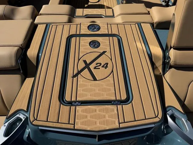 Slide: The Image of 2025 MasterCraft X24 boat deck with sleek wood finish and logo detailing. - 9