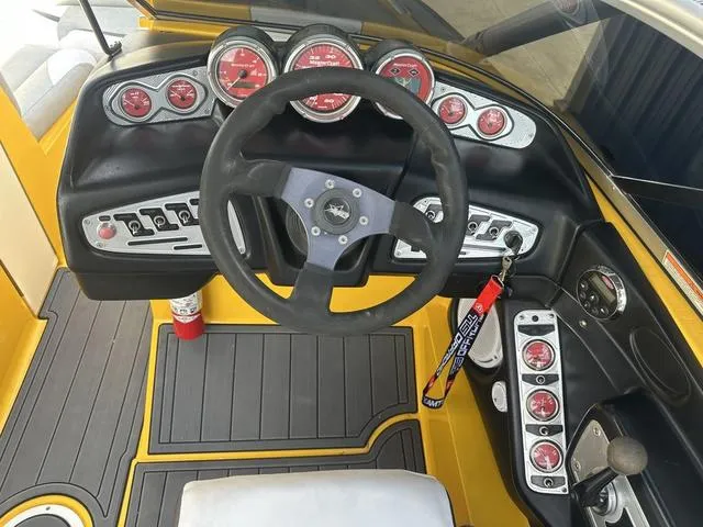 Slide: The Image of 2006 MasterCraft X2 boat dashboard with steering wheel and gauges. - 11