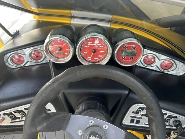 Slide: The Image of 2006 MasterCraft X2 dashboard with red gauges and steering wheel. - 12
