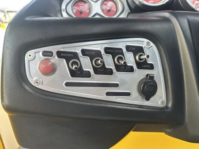 Slide: The Image of Control panel of a 2006 MasterCraft X2 boat with various switches and gauges. - 13