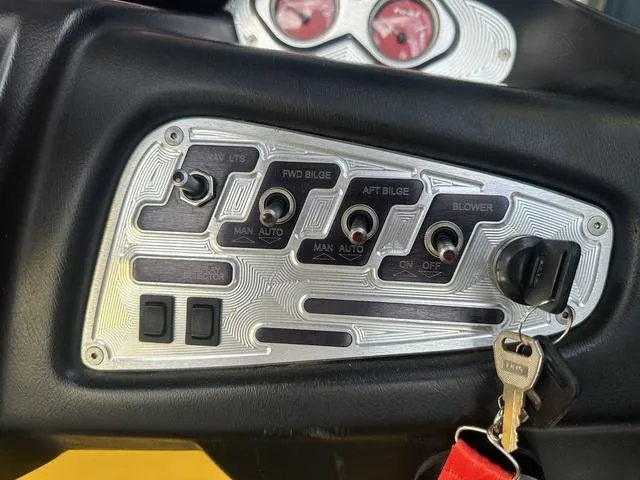 Slide: The Image of Control panel of a 2006 MasterCraft X2 boat with switches and ignition keys. - 14