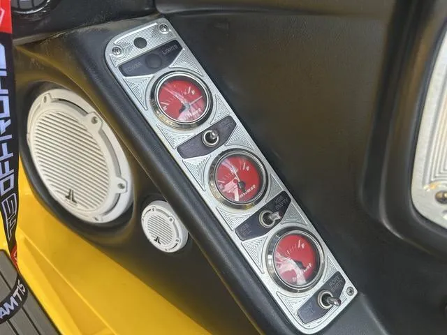Slide: The Image of 2006 MasterCraft X2 dashboard with red gauges and speakers. - 15