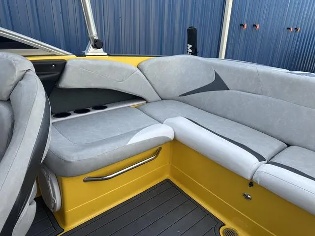 Slide: The Image of 2006 MasterCraft X2 boat interior with gray and yellow seating, cup holders, and sleek design. - 16