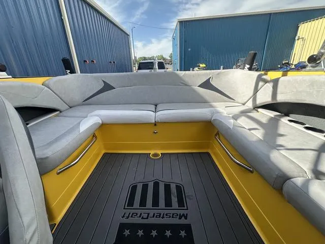 Slide: The Image of 2006 MasterCraft X2 boat interior with gray seating and yellow accents. - 17
