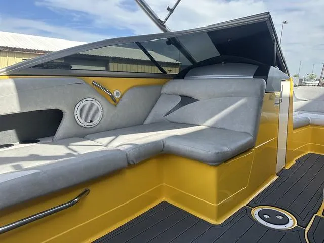 Slide: The Image of 2006 MasterCraft X2 boat interior with yellow accents and gray seating. - 20