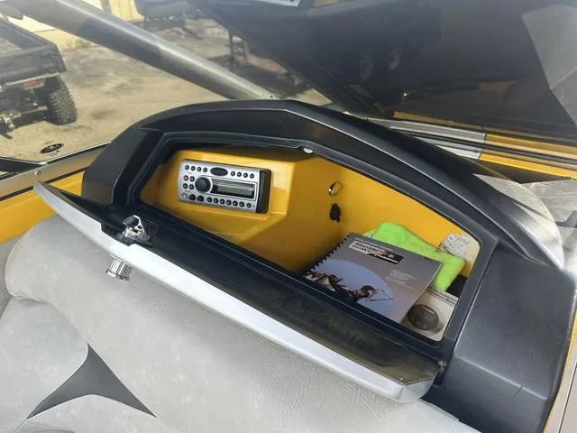 Slide: The Image of 2006 MasterCraft X2 dashboard with storage compartment, stereo, and manual. - 21