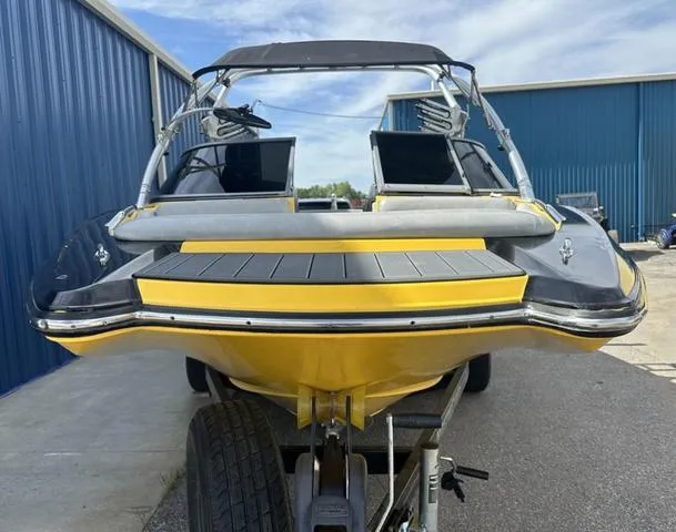 Slide: The Image of 2006 MasterCraft X2 boat with yellow and black design on a trailer. - 3