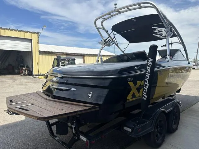 Slide: The Image of 2006 MasterCraft X2 boat on trailer, parked outside a warehouse. - 6