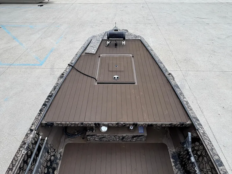 Slide: The Image of 2024 Pro-Drive X-Series TD Edition boat deck with storage compartment, camo design. - 10