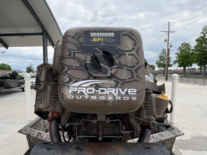 Slide: The Image of 2024 Pro-Drive X-Series TD Edition outboard motor with camouflage design, parked outdoors. - 11