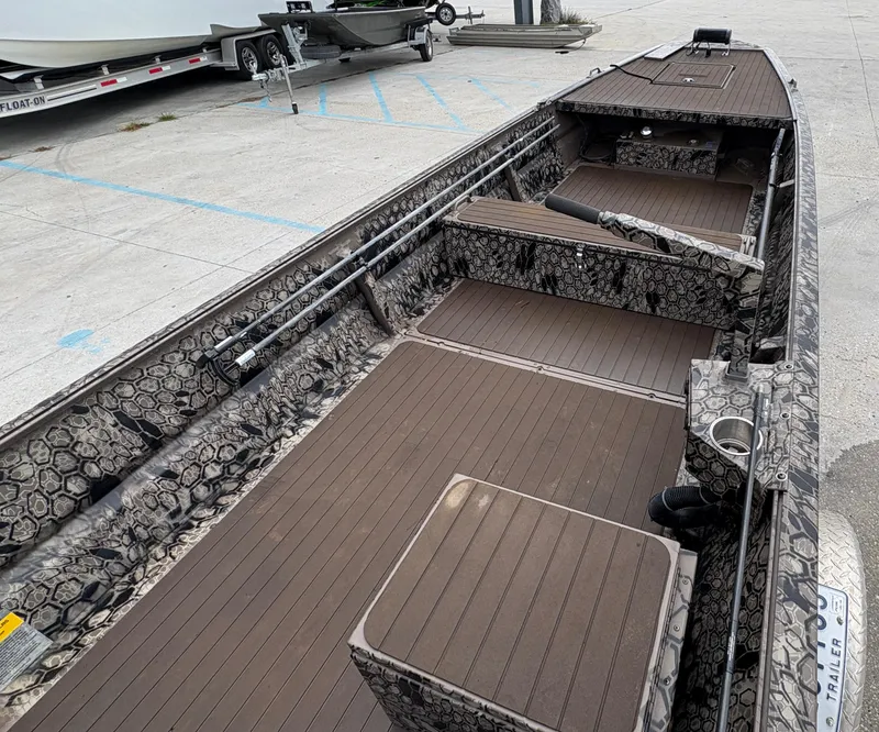 Slide: The Image of 2024 Pro-Drive X-Series TD Edition boat with camouflage interior and spacious deck layout. - 5