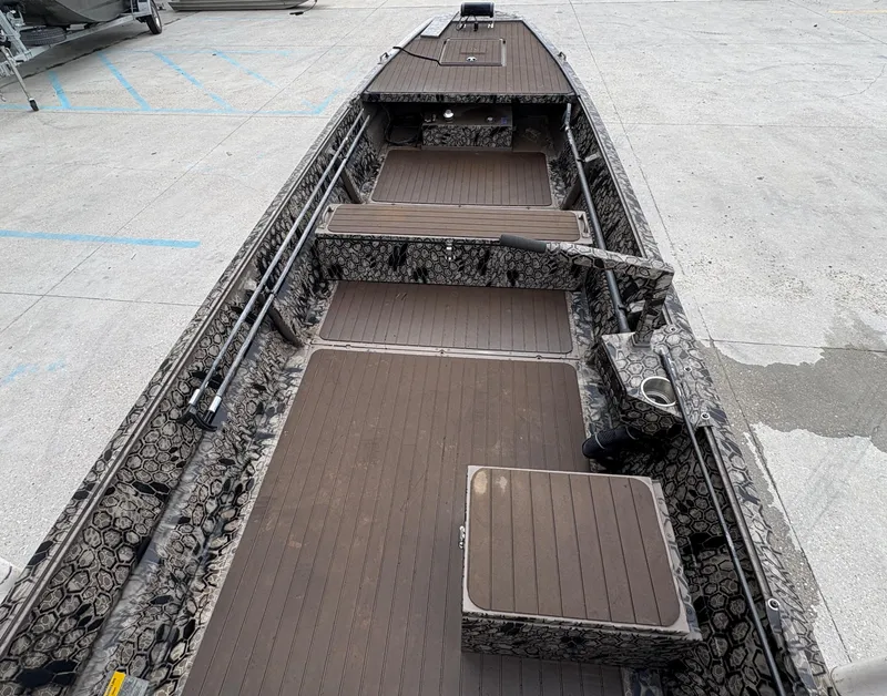 Slide: The Image of 2024 Pro-Drive X-Series TD Edition boat with camo design and spacious deck layout. - 6