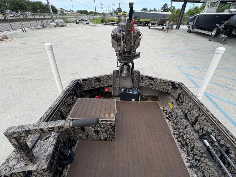 Slide: The Image of 2024 Pro-Drive X-Series TD Edition boat interior with camouflage design and motor. - 8