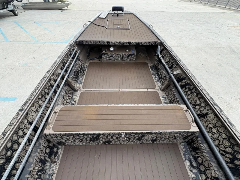 Slide: The Image of 2024 Pro-Drive X-Series TD Edition boat with camouflage interior and spacious deck layout. - 9