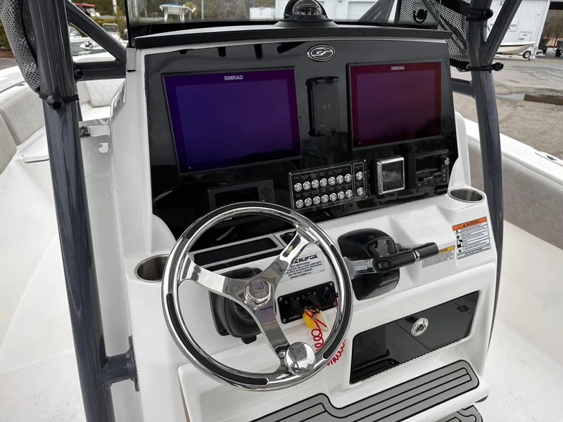 Slide: The Image of 2021 Sea Fox 288 Commander dashboard with dual Simrad displays and steering wheel. - 10