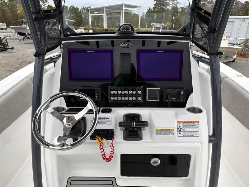 Slide: The Image of 2021 Sea Fox 288 Commander boat dashboard with dual screens and steering wheel. - 11