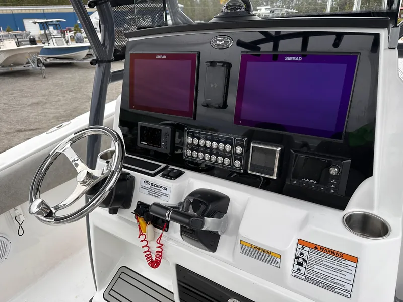 Slide: The Image of 2021 Sea Fox 288 Commander dashboard with dual Simrad displays and steering wheel. - 12